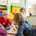 Children play a wooden game together